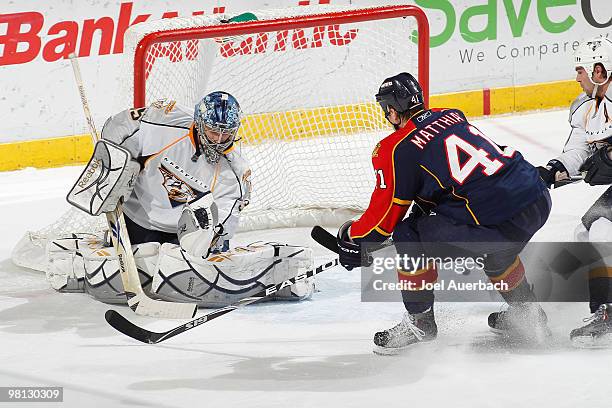 Goaltender Dan Ellis of the Nashville Predators stops a shot by the Florida Panthers as Shawn Matthias waits for a rebound on March 29, 2010 at the...