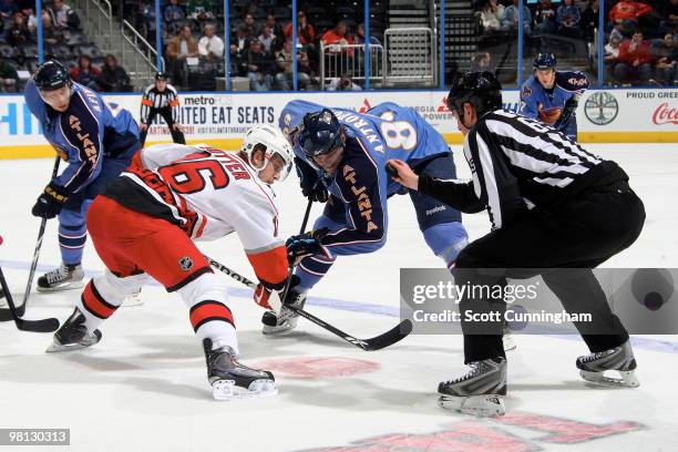 Brandon Sutter of the Carolina Hurricanes faces off against Nik Antropov of the Atlanta Thrashers at Philips Arena on March 29, 2010 in Atlanta,...