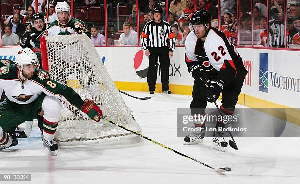Ville Leino of the Philadelphia Flyers passes the puck from behind his net against Brent Burns of the Minnesota Wild on March 25, 2010 at the...