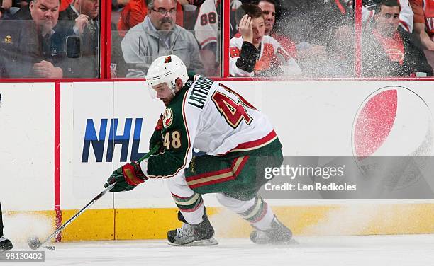 Guillaume Latendresse of the Minnesota Wild skates the puck along the boards against the Philadelphia Flyers on March 25, 2010 at the Wachovia Center...