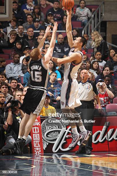 Yi Jianlian of the New Jersey Nets shoots against Matt Bonner of the San Antonio Spurs on March 29, 2010 at the IZOD Center in East Rutherford, New...