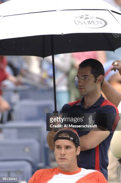 Tommy Haas waits under an umbrella during a fourth-round men's singles match against Marat Safin September 5, 2006 during the 2006 US Open in...