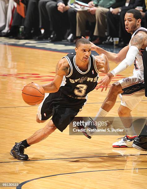 George Hill of the San Antonio Spurs drives against Devin Harris of the New Jersey Nets on March 29, 2010 at the IZOD Center in East Rutherford, New...