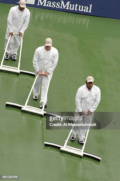 Workers clear the court as rain delays the Marat Safin - Tommy Haas fourth-round men's singles match September 5, 2006 during the 2006 US Open in...