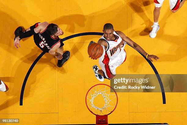 Watson of the Golden State Warriors shoots a layup against Rudy Fernandez of the Portland Trail Blazers during the game at Oracle Arena on March 11,...