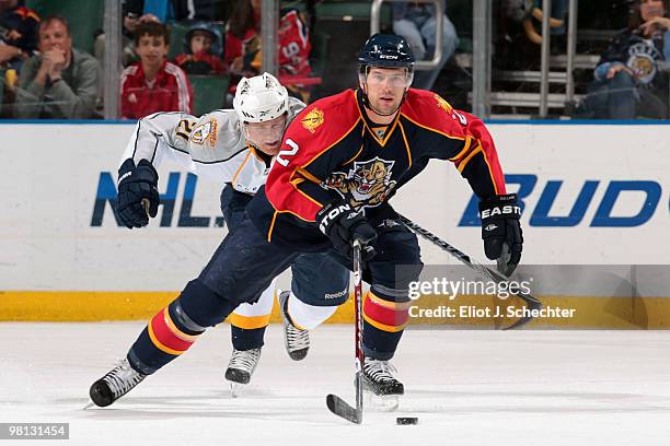 Keith Ballard of the Florida Panthers skates with the puck against Patric Hornqvist of the Nashville Predators at the BankAtlantic Center on March...