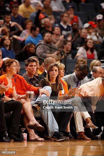 Denny Hamlin after his race is seen sitting next to Jordan Fish during the game of the Charlotte Bobcats against Antoine Wright of the Toronto...