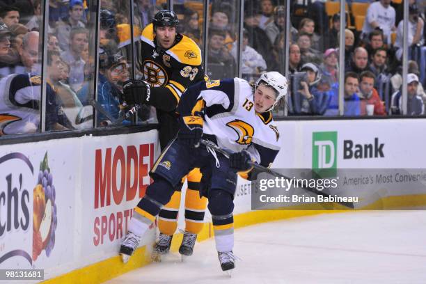 Zdeno Chara of the Boston Bruins checks Tim Kennedy of the Buffalo Sabres at the TD Garden on March 29, 2010 in Boston, Massachusetts.