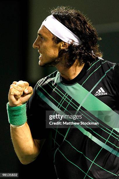 Juan Monaco of Argentina celebrates breaking Fernando Gonzalez of Chile in the first set during day seven of the 2010 Sony Ericsson Open at Crandon...