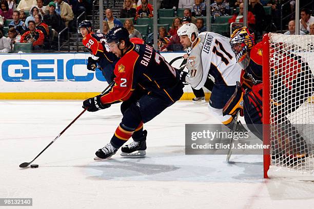 Keith Ballard of the Florida Panthers skates with the puck against David Legwand of the Nashville Predators at the BankAtlantic Center on March 29,...