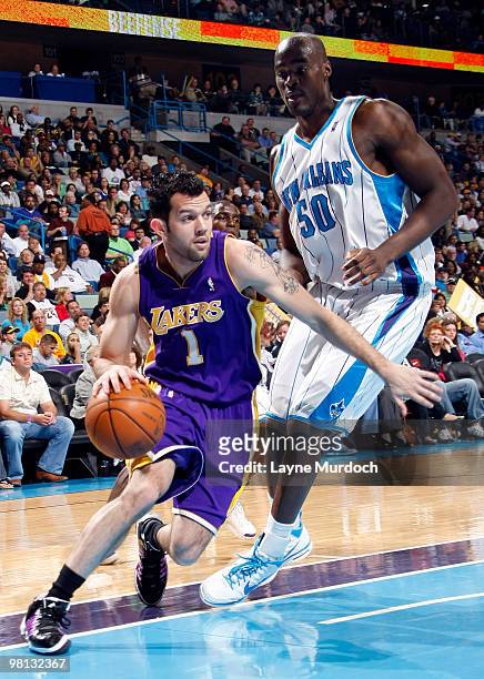 Jordan Farmar of the Los Angeles Lakers drives around Emeka Okafor of the New Orleans Hornets on March 29, 2010 at the New Orleans Arena in New...