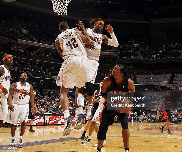 Gerald Wallace of the Charlotte Bobcats blocks against Chris Bosh of the Toronto Raptors on March 29, 2010 at the Time Warner Cable Arena in...
