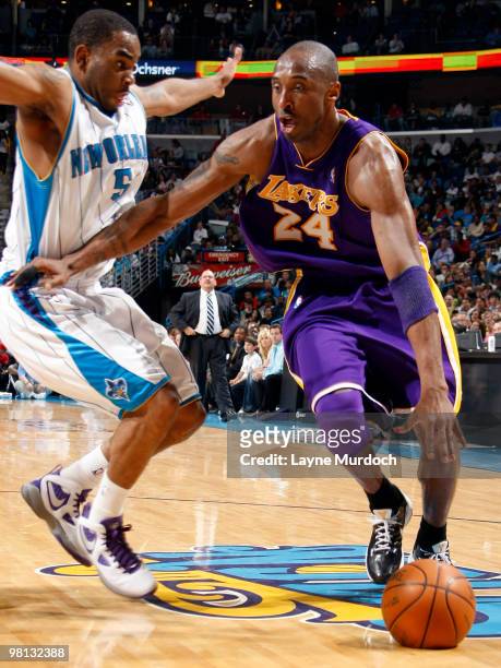 Kobe Bryant of the Los Angeles Lakers drives around Marcus Thornton of the New Orleans Hornets on March 29, 2010 at the New Orleans Arena in New...