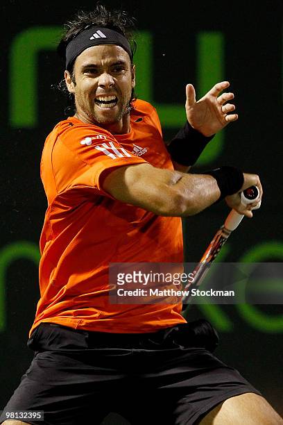 Fernando Gonzalez of Chile returns a shot to Juan Monaco of Argentina during day seven of the 2010 Sony Ericsson Open at Crandon Park Tennis Center...