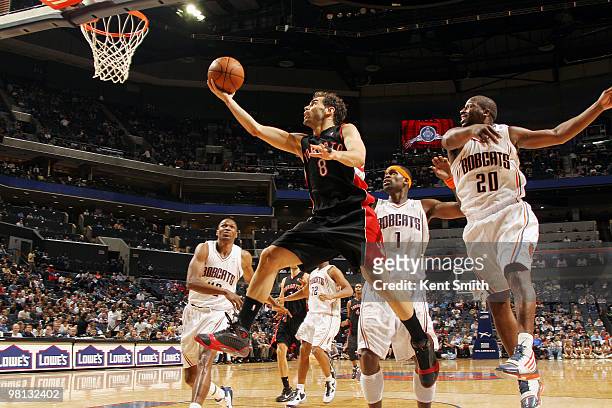 Jose Calderon of the Toronto Raptors goes for the layup against Raymond Felton of the Charlotte Bobcats on March 29, 2010 at the Time Warner Cable...
