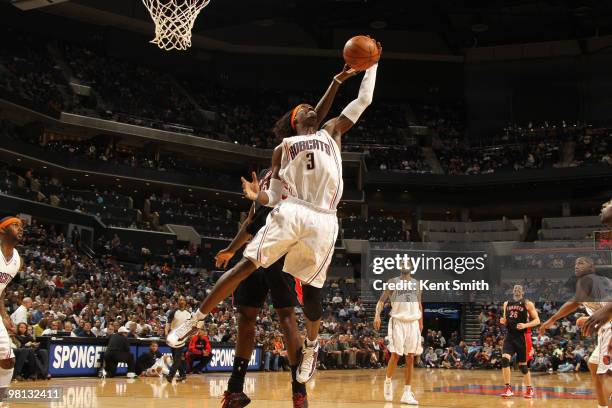 Amir Johnson of the Toronto Raptors blocks against Gerald Wallace of the Charlotte Bobcats on March 29, 2010 at the Time Warner Cable Arena in...