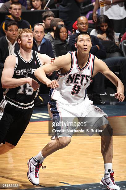 Yi Jianlian of the New Jersey Nets defends against Matt Bonner of the San Antonio Spurs on March 29, 2010 at the IZOD Center in East Rutherford, New...