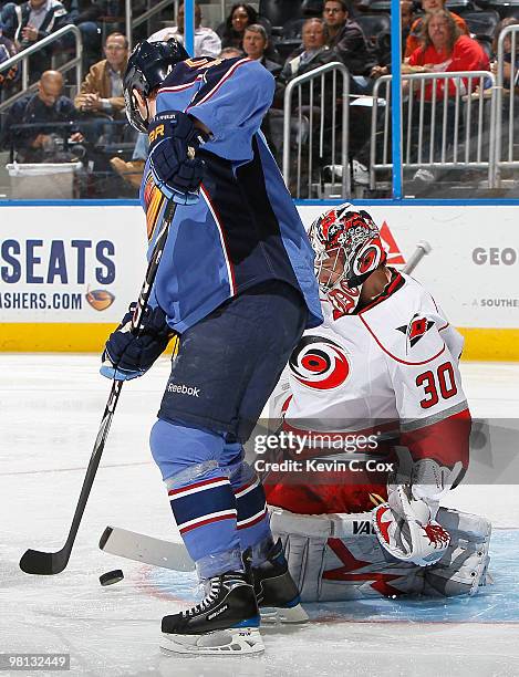 Goaltender Cam Ward of the Carolina Hurricanes saves a shot on goal by Rich Peverley of the Atlanta Thrashers at Philips Arena on March 29, 2010 in...