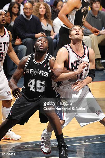 Brook Lopez of the New Jersey Nets looks for the rebound against DeJuan Blair of the San Antonio Spurs on March 29, 2010 at the IZOD Center in East...