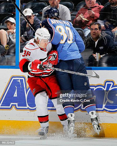 Nik Antropov of the Atlanta Thrashers collides with Jussi Jokinen of the Carolina Hurricanes at Philips Arena on March 29, 2010 in Atlanta, Georgia.