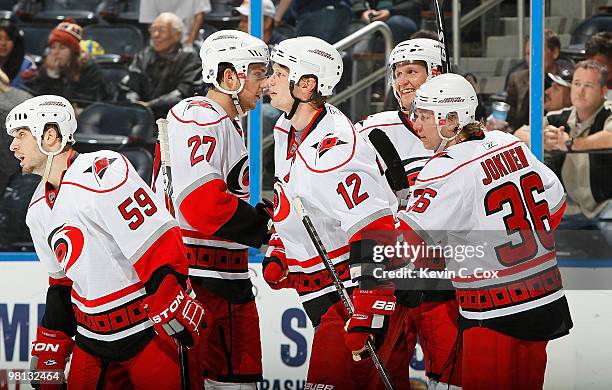 Jussi Jokinen of the Carolina Hurricanes celebrates his empty net goal against the Atlanta Thrashers with his teammates at Philips Arena on March 29,...