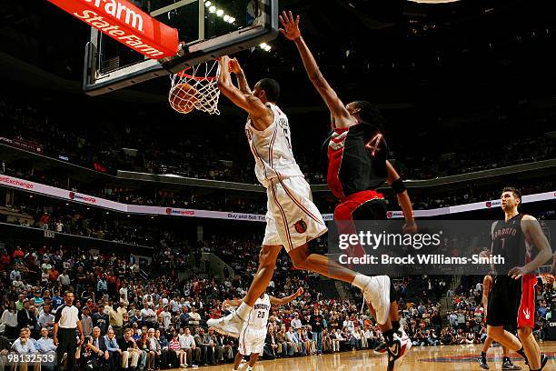 Tyson Chandler of the Charlotte Bobcats dunks against Chris Bosh of the Toronto Raptors on March 29, 2010 at the Time Warner Cable Arena in...