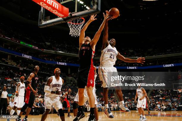 Raymond Felton of the Charlotte Bobcats blocks against Andrea Bargnani of the Toronto Raptors on March 29, 2010 at the Time Warner Cable Arena in...