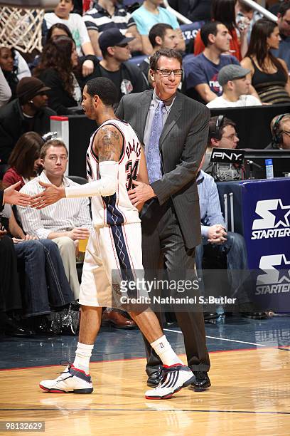 Devin Harris and head coach Kiki Vandeweghe of the New Jersey Nets interact during game against the San Antonio Spurs on March 29, 2010 at the IZOD...