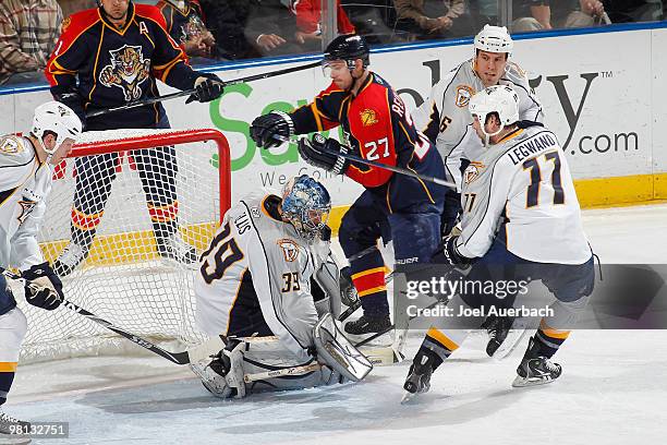 Goaltender Dan Ellis of the Nashville Predators stops a shot by Steven Reinprecht of the Florida Panthers on March 29, 2010 at the BankAtlantic...