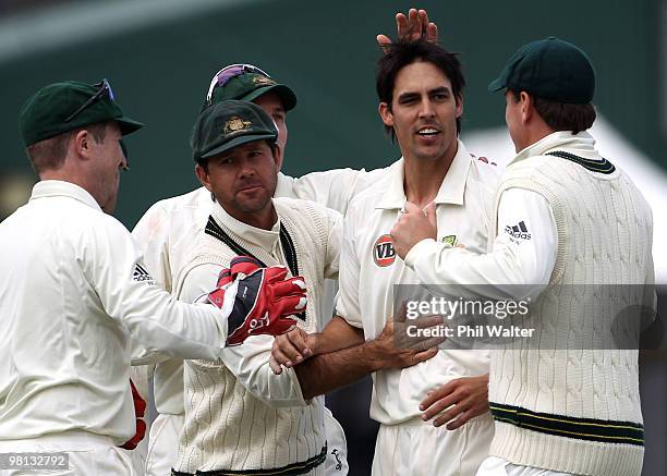 Mitchell Johnson of Australia is congratulated by Ricky Ponting after bowling Tim McIntosh of New Zealand during day four of the Second Test match...
