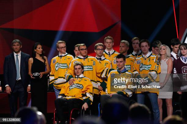 Alex Ovechkin of the Washington Capitals, far left, stands onstage with the Humboldt Broncos and Christina Haugan, far right, wife Broncos coach...