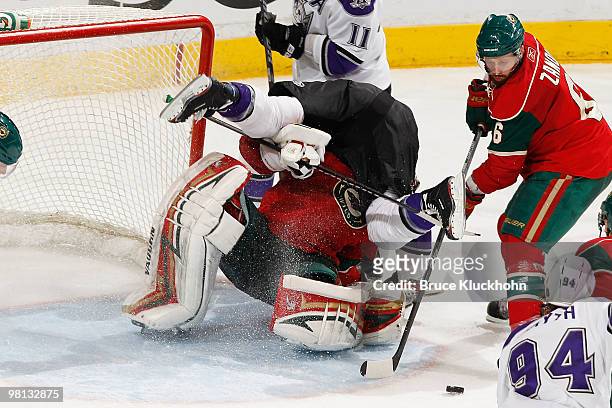 Jeff Halpern of the Los Angeles Kings is called for goalkeeper interference after colliding with Niklas Backstrom of the Minnesota Wild during the...