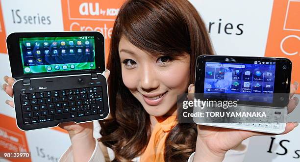 Model shows off the new smartphone "IS01" built on the Android operating system and the "IS02" built on the Windows operating system during a press...