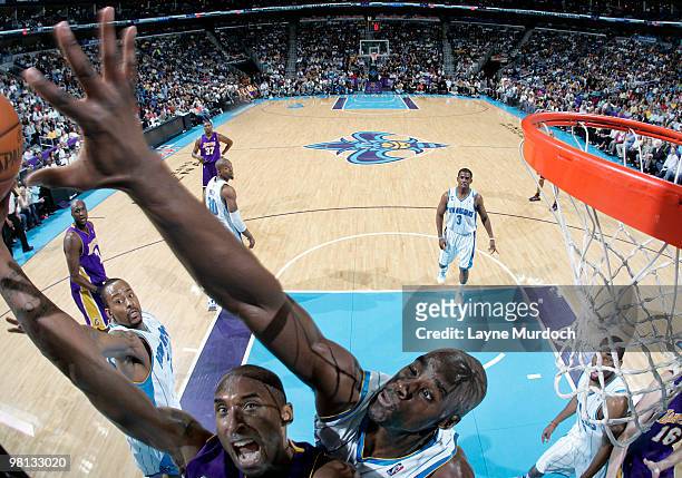 Kobe Bryant of the Los Angeles Lakers goes up for a shot against Emeka Okafor of the New Orleans Hornets on March 29, 2010 at the New Orleans Arena...