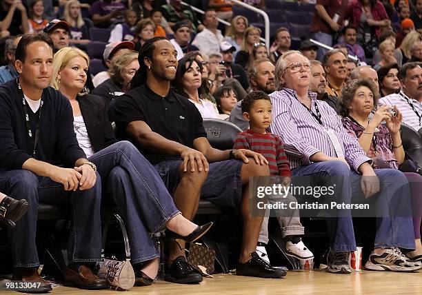 Wide receiver Larry Fitzgerald of the Arizona Cardinals and his son attend the NBA game between the Portland Trail Blazers and the Phoenix Suns at US...