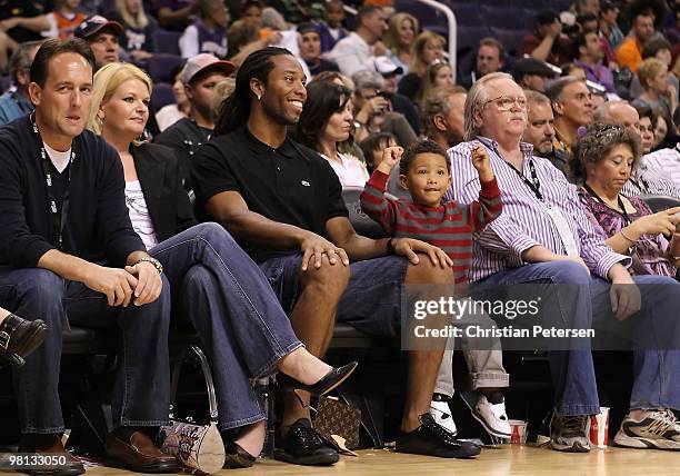 Wide receiver Larry Fitzgerald of the Arizona Cardinals and his son attend the NBA game between the Portland Trail Blazers and the Phoenix Suns at US...