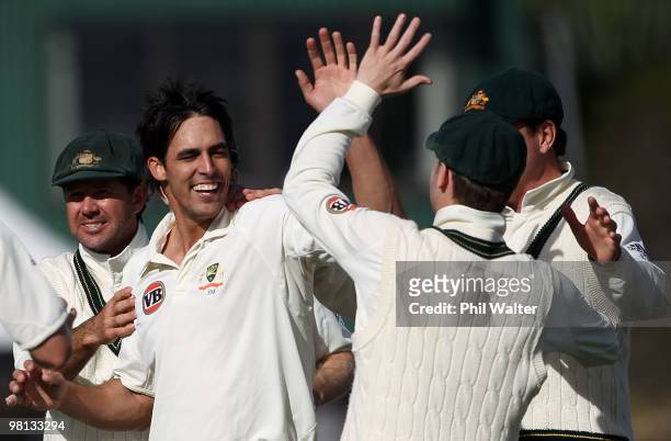 Mitchell Johnson of Australia celebrates his wicket of Ross Taylor of New Zealand during day four of the Second Test match between New Zealand and...
