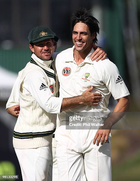 Mitchell Johnson of Australia is congratulated by Ricky Ponting as he celebrates his wicket of Ross Taylor of New Zealand during day four of the...