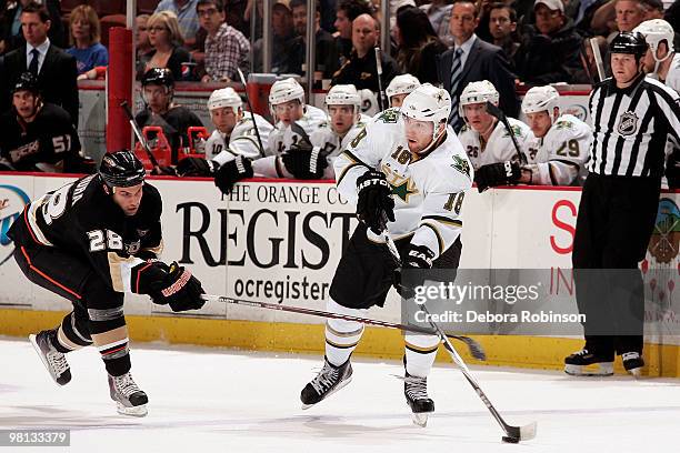Kyle Chipchura of the Anaheim Ducks reaches around for the puck against James Neal of the Dallas Stars during the game on March 29, 2010 at Honda...