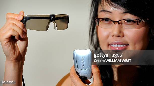 Researcher Mandy Li displays a prototype bionic eye designed to help patients suffering from degenerative vision loss caused by retinitis pigmentosa...