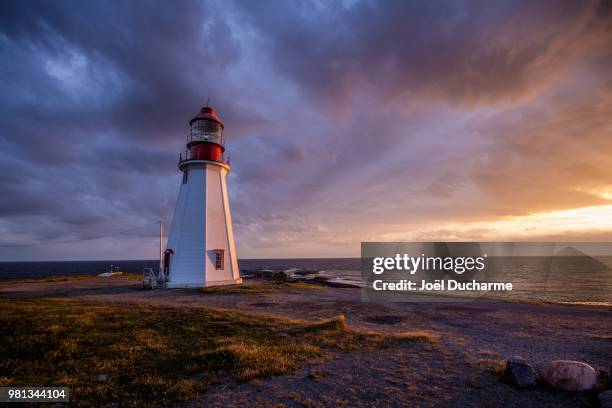 point riche lighthouse at sunset, point riche, newfoundland and labrador, canada - point riche lighthouse stock pictures, royalty-free photos & images
