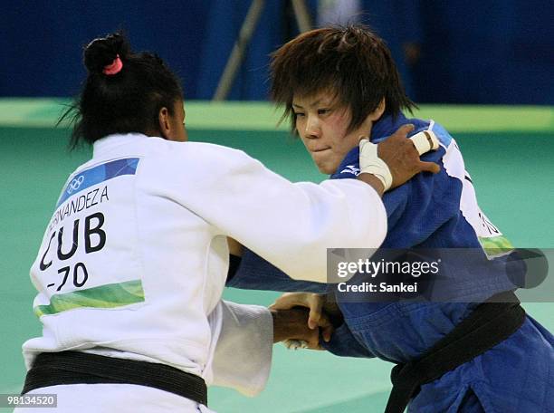 Masae Ueno of Japan and Anaysi Hernandez of Cuba comeptes during the Women's 70 kg judo competition at the University of Science and Technology...