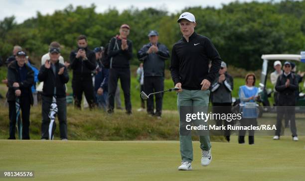 Conner Purcell of Portmarnock reacts after sinking a putt to save the match at the 14th hole during the Semi final of The Amateur Championship at...