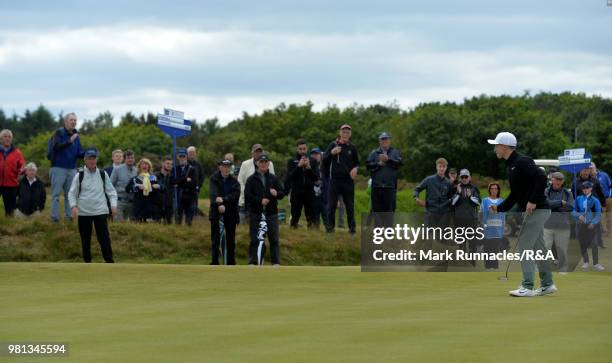 Conner Purcell of Portmarnock reacts after sinking a putt to save the match at the 14th hole during the Semi final of The Amateur Championship at...