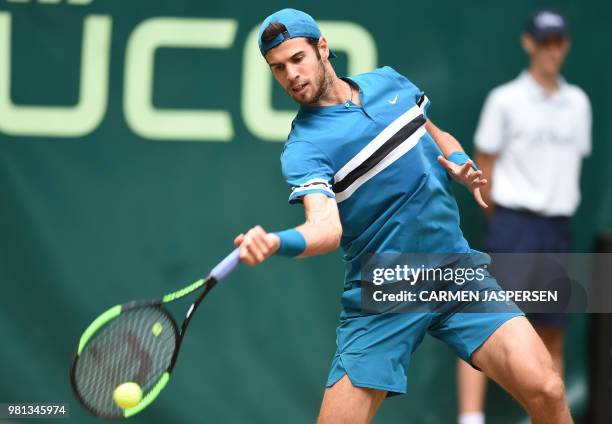 Karen Khachanov from Russia returns the ball to Roberto Bautista Agut from Spain during their match at the ATP Gerry Weber Open tennis tournament in...