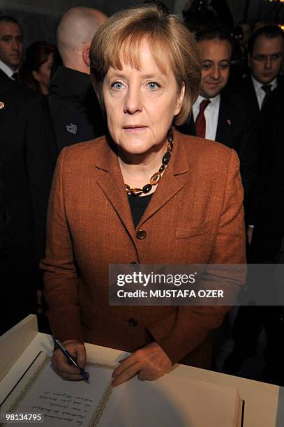 German Chancellor Angela Merkel signs the guestbook after visiting the Hagia Sophia museum in Istanbul on March 30, 2010. Merkel arrived on March 29...