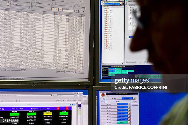 European Organization for Nuclear Research scientist looks at a monitor in the Alice experiment control room on March 30, 2010 near Geneva during an...