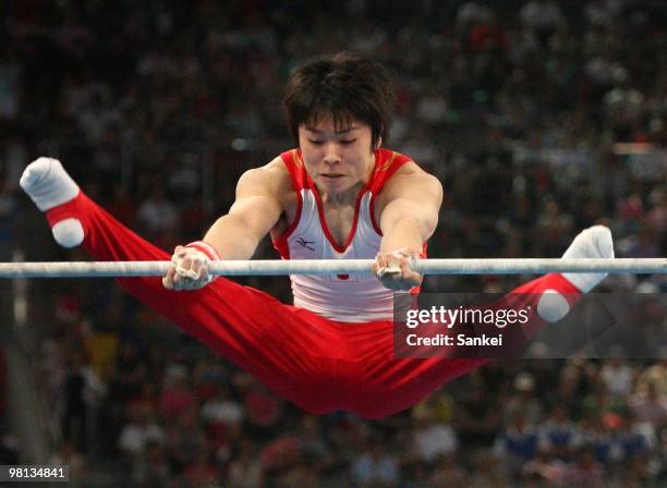 Kohei Uchimura of Japan competes in the Horizontal Bar during the men's team final of the artistic gymnastics event held at the National Indoor...