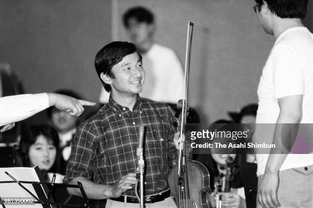 Prince Naruhito is seen during a practice session ahead of his viola solo performance at Aoyama Gakuin University on May 24, 1987 in Tokyo, Japan.