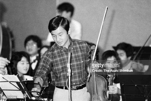 Prince Naruhito is seen during a practice session ahead of his viola solo performance at Aoyama Gakuin University on May 24, 1987 in Tokyo, Japan.